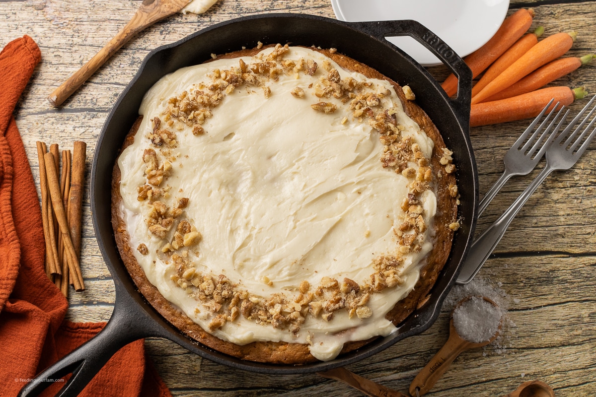 frosted carrot cake in a cast iron skillet