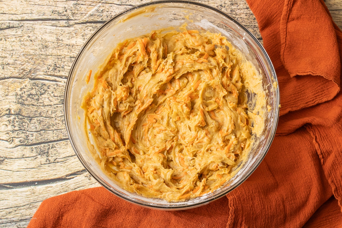 carrot cake batter in a glass mixing bowl