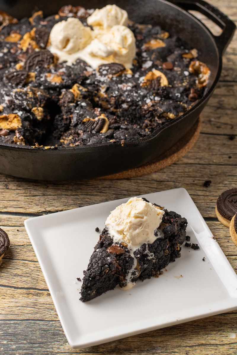 black skillet cookie slice topped with ice cream
