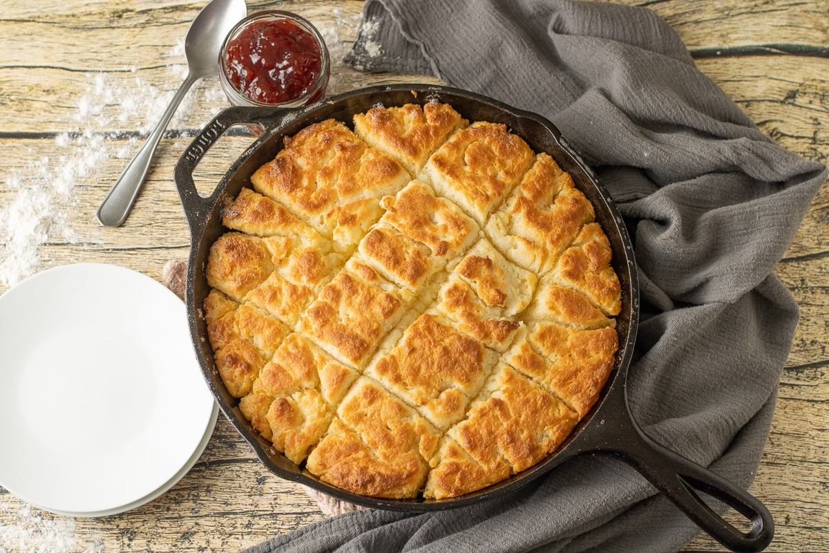 golden brown butter swim biscuits in a cast iron skillet