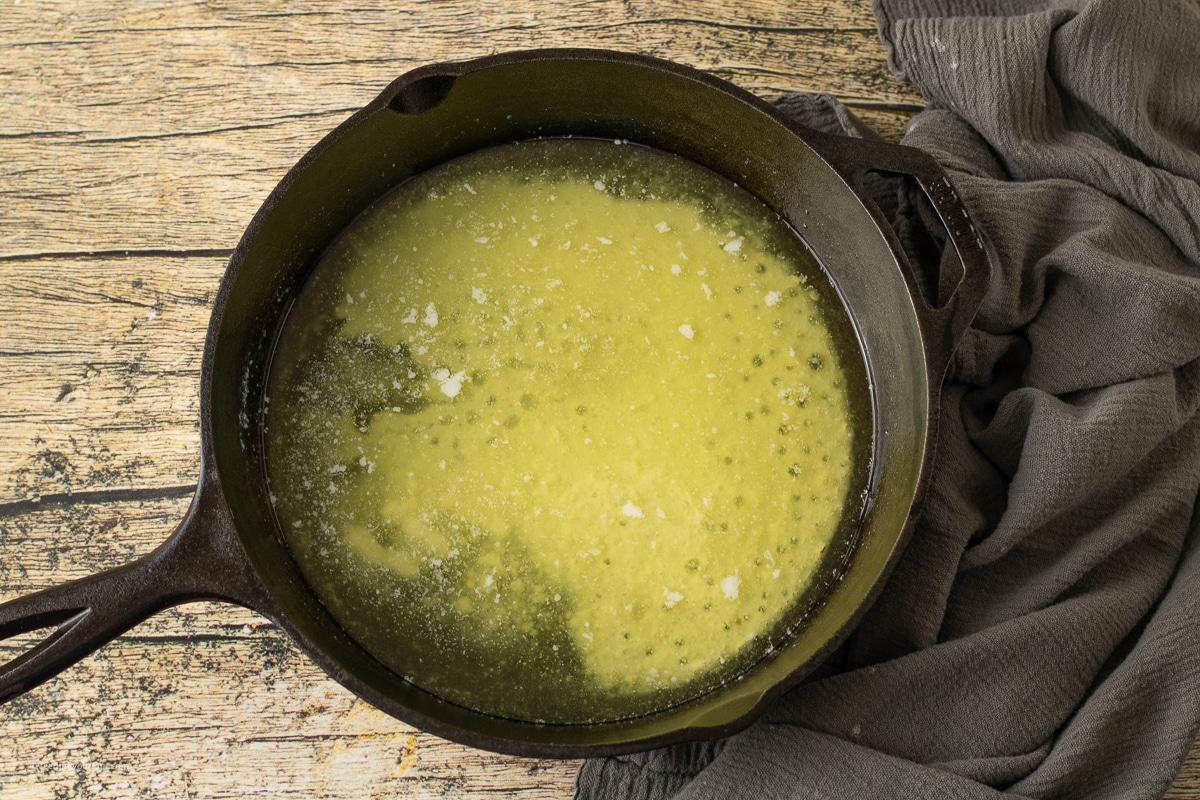 melted butter in a cast iron skillet for butter swim biscuits