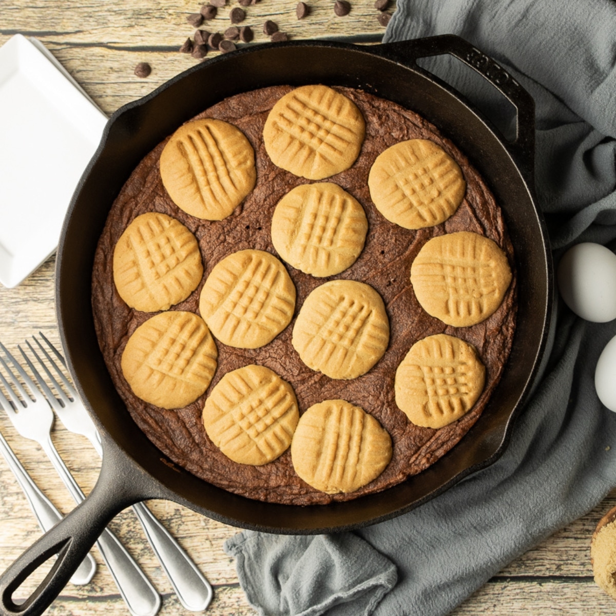 peanut butter cookie topped brownie in a cast iron skillet