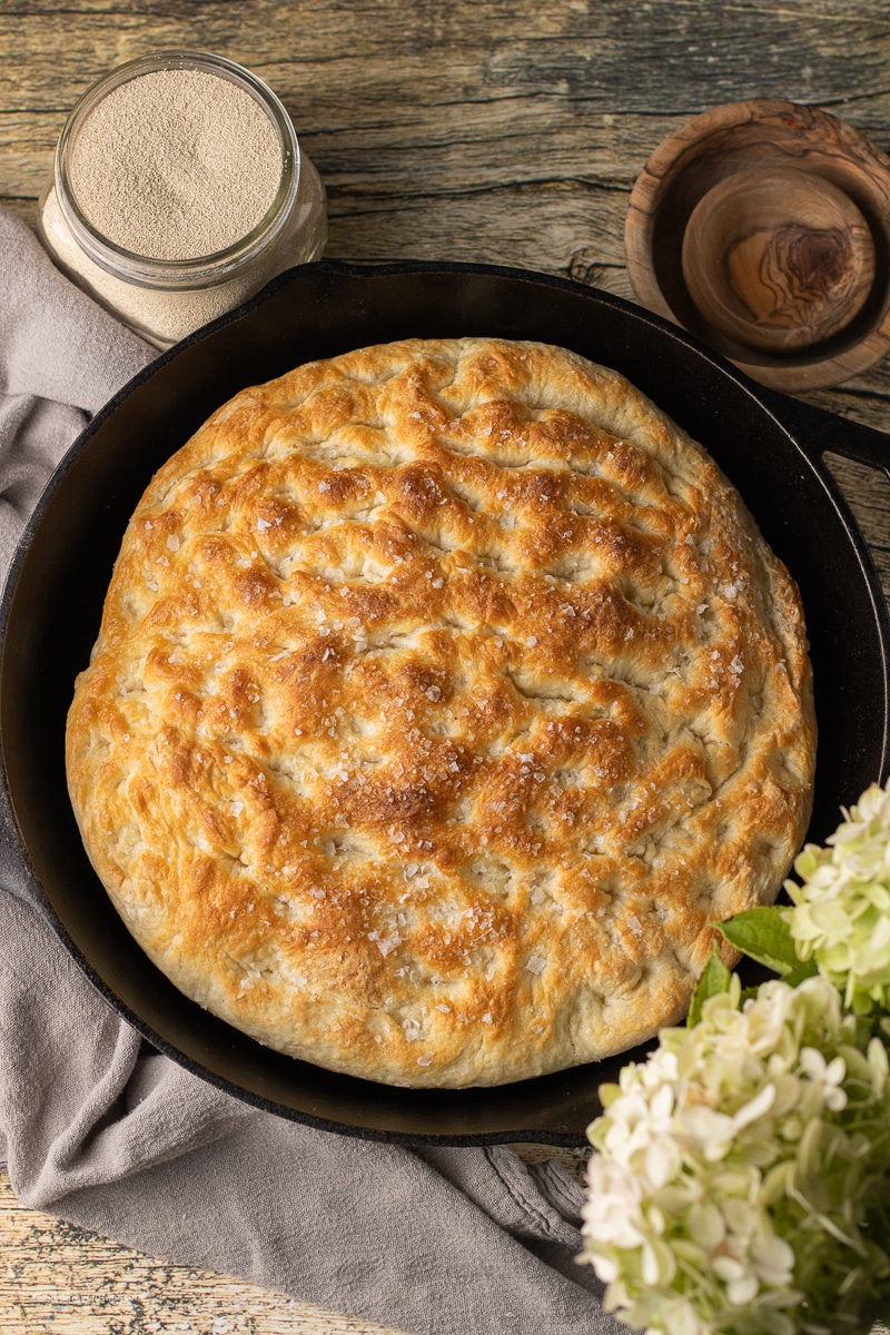 overhead view of focaccia baked in a cast iron skillet