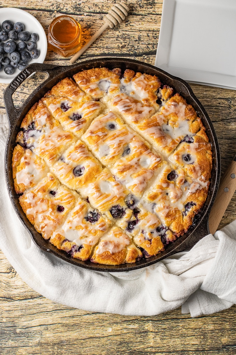 blueberry butter swim biscuits baked in a cast iron skillet
