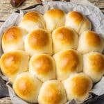 golden brown homemade dinner rolls in a cast iron skillet