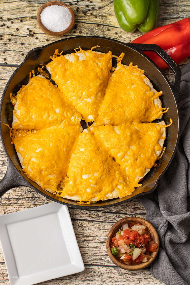 breakfast hot pockets topped with melted cheese in a cast iron skillet