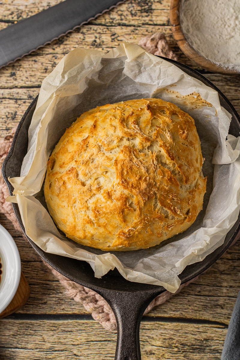 small loaf of homemade bread in a cast iron skillet