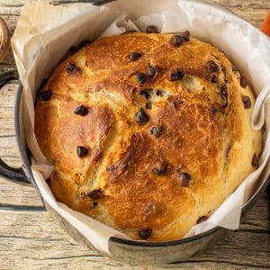 chocolate chip bread in a dutch oven pan lined with parchment paper
