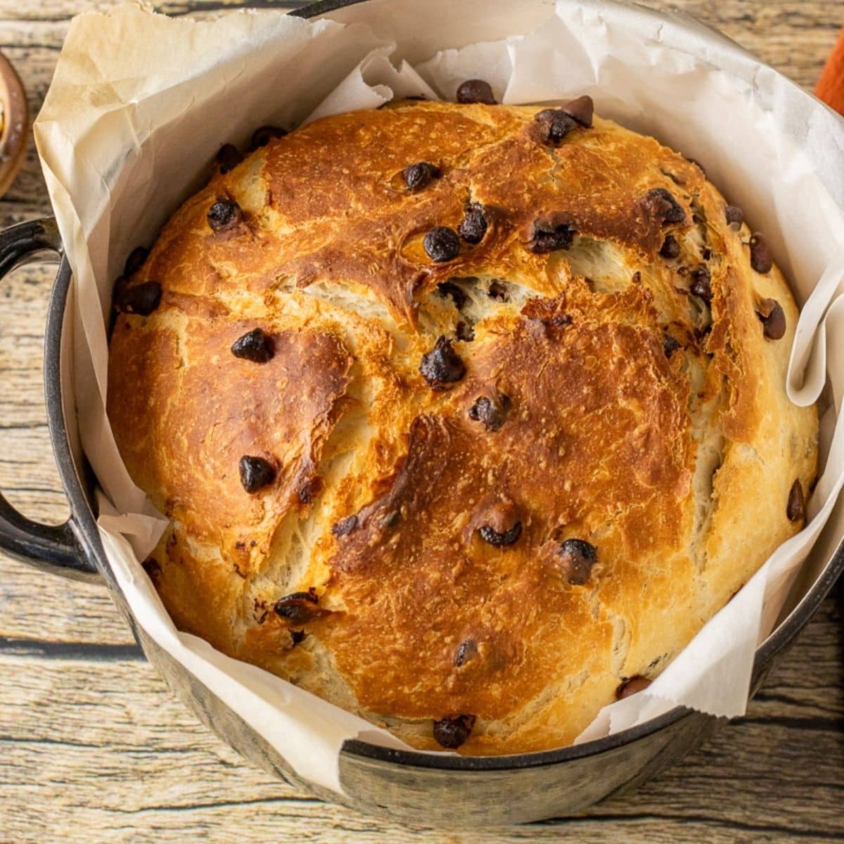 chocolate chip bread in a dutch oven pan lined with parchment paper