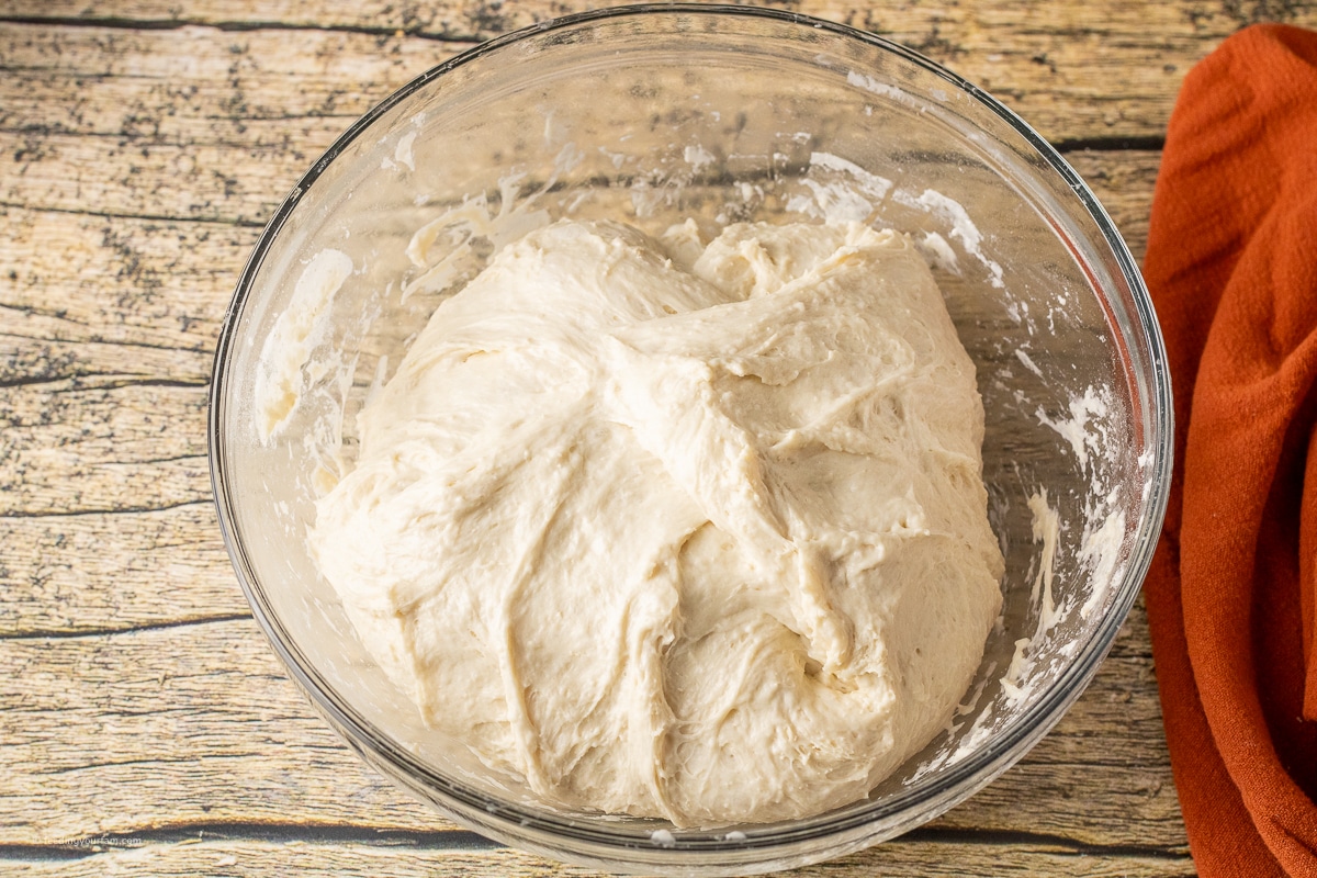 soft bread dough in a glass mixing bowl