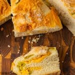 crusty jalapeño cheddar bread sliced on cutting board