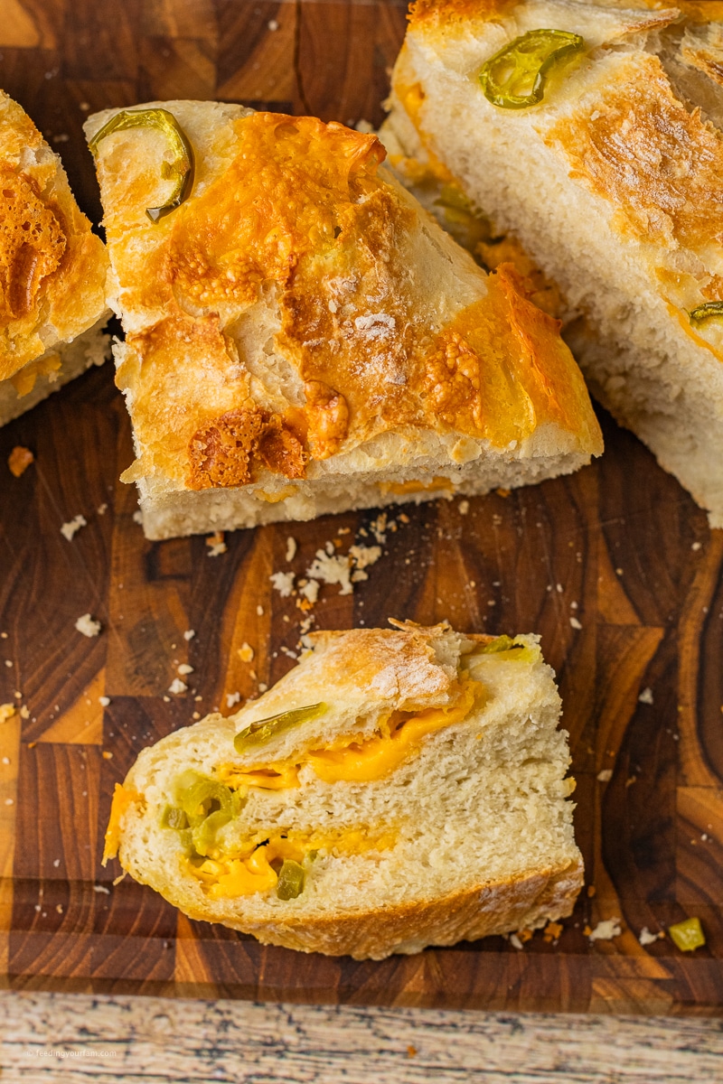 dutch oven crusty jalapeño cheddar bread sliced on cutting board