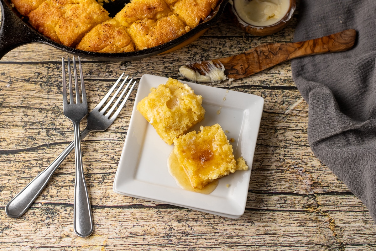 split open cornbread butter swim biscuit topped with melted butter and warm honey