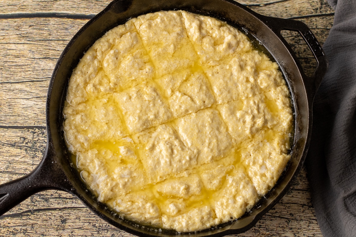 uncooked cornmeal butter swim biscuits in a cast iron skillet