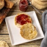 homemade English muffins are cooked in a cast iron skillet on the stovetop for a soft, chewy texture with classic nooks and crannies.