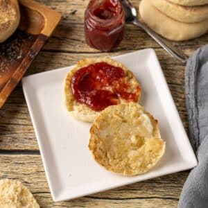 homemade English muffins are cooked in a cast iron skillet on the stovetop for a soft, chewy texture with classic nooks and crannies.